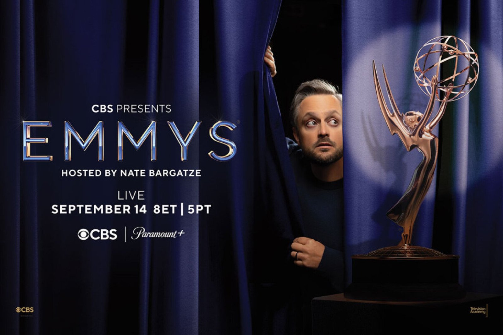 Nate Bargatze peeking behind curtain with Emmy award