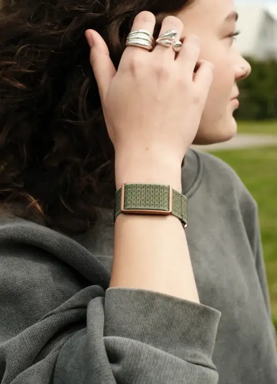 polar loop fitness tracker on woman's arm