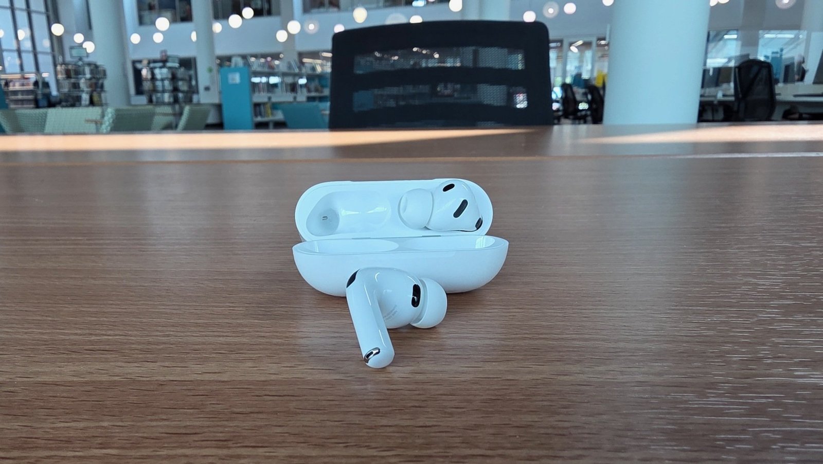 airpods pro 3 and charging case on desk
