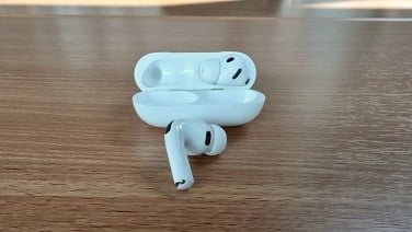 airpods pro 3 and charging case on desk