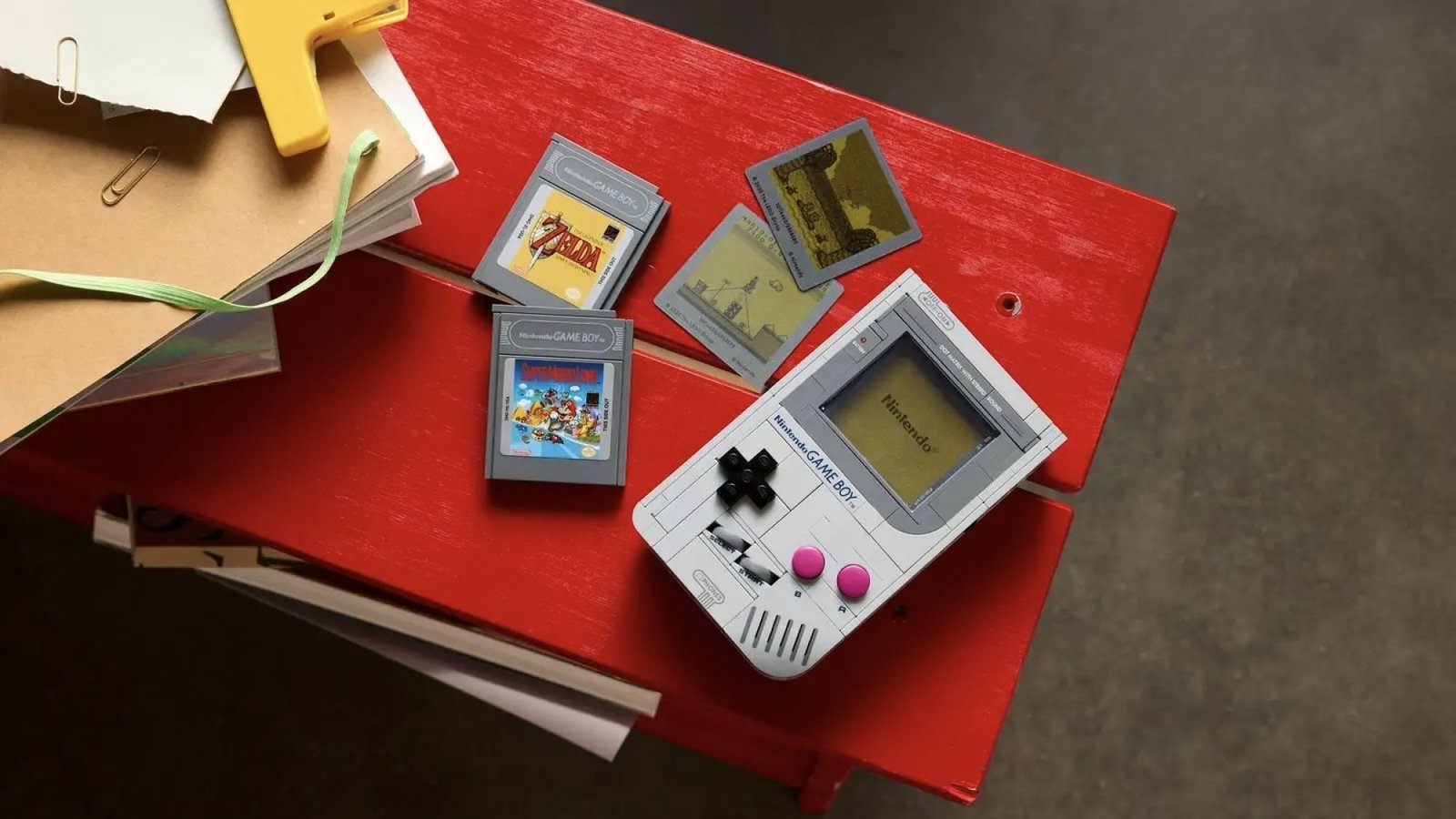 lego game boy with game paks on red bench