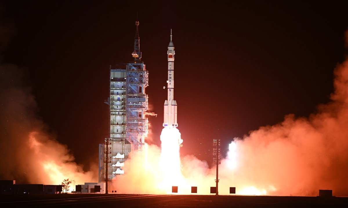 Rocket launch at night with flames and smoke, showcasing the powerful ascent of a spacecraft from the launch pad.