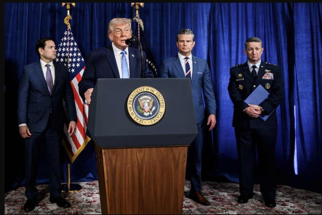 Former President Donald Trump speaks at a podium with the presidential seal, flanked by other officials during a press event.