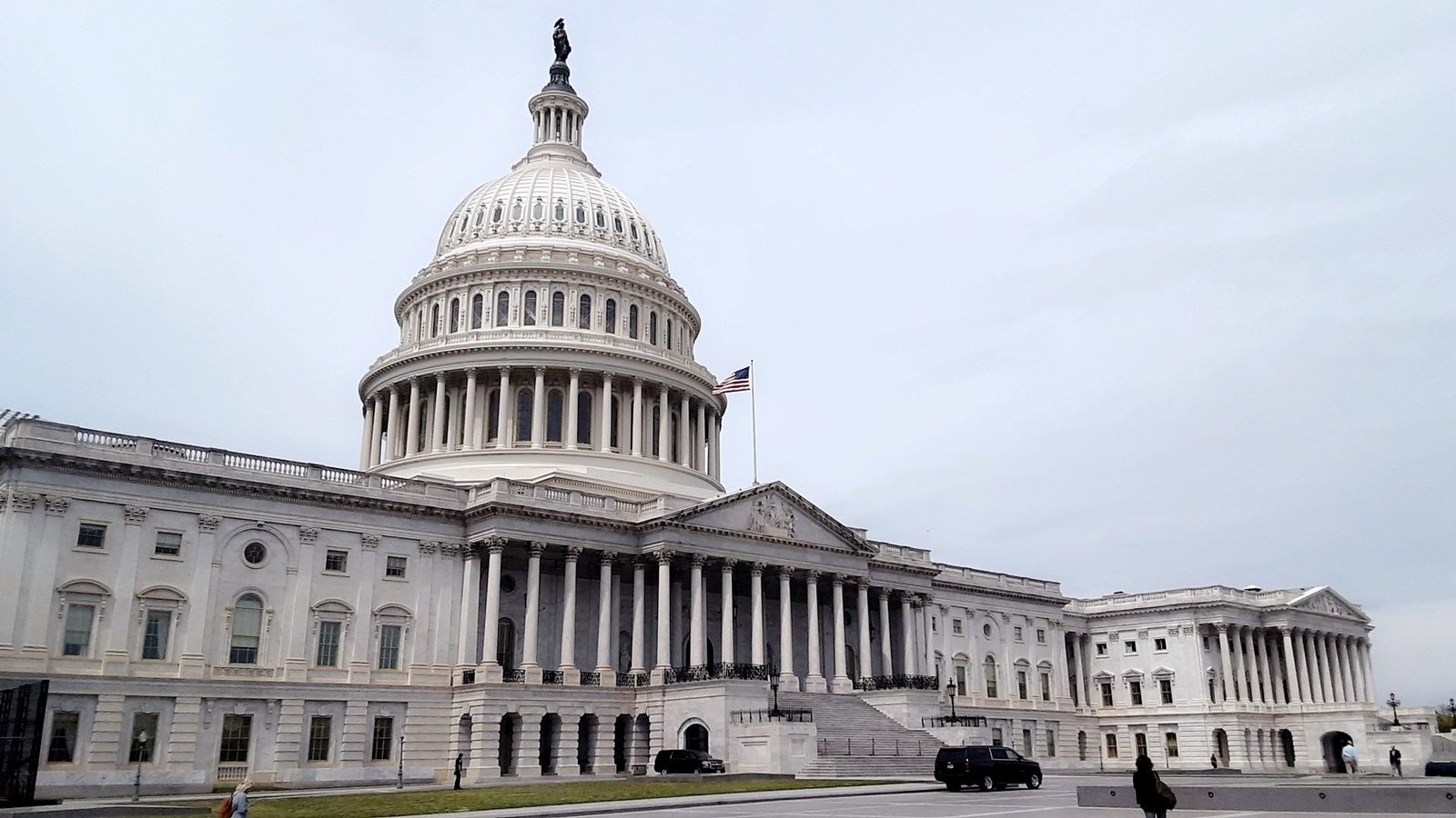 United States Capitol building showcasing its iconic dome and architectural details under a cloudy sky.