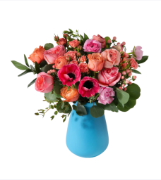 Orange and pink flowers in blue vase