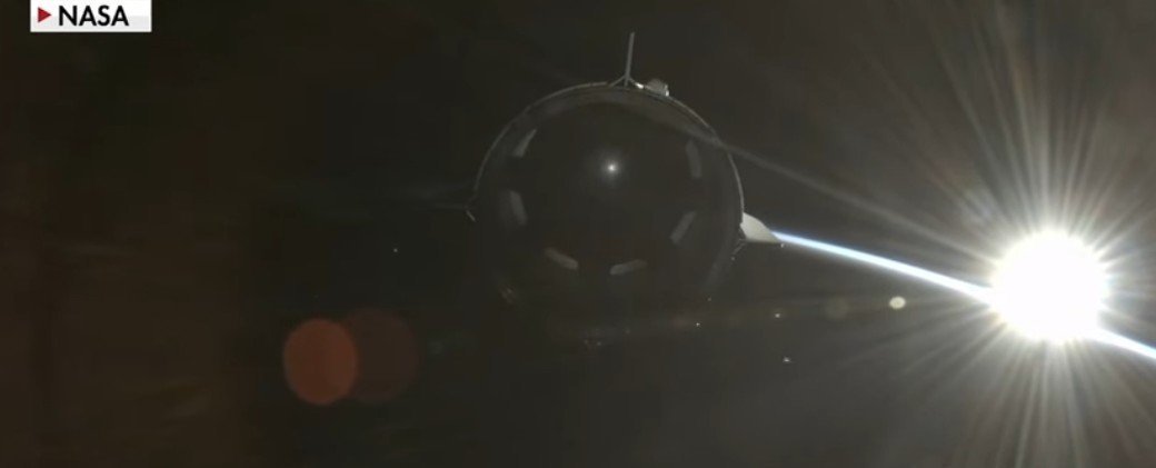 NASA spacecraft approaches the sun, showcasing a stunning view of solar flares and the curvature of Earth in the background.