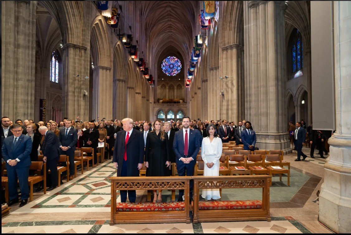 Former President Donald Trump and family attending a solemn ceremony at a cathedral, surrounded by a large audience in formal attire.